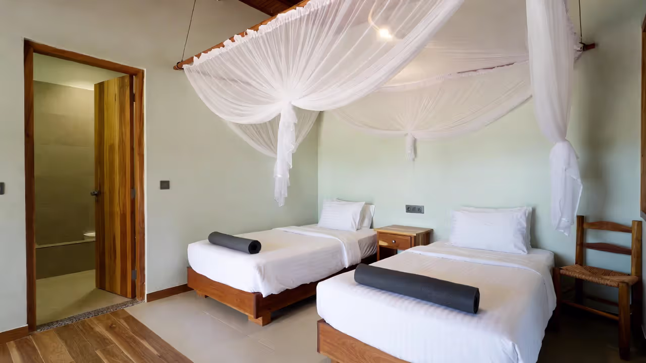 Shared dorm-style accommodation at a yoga retreat center.