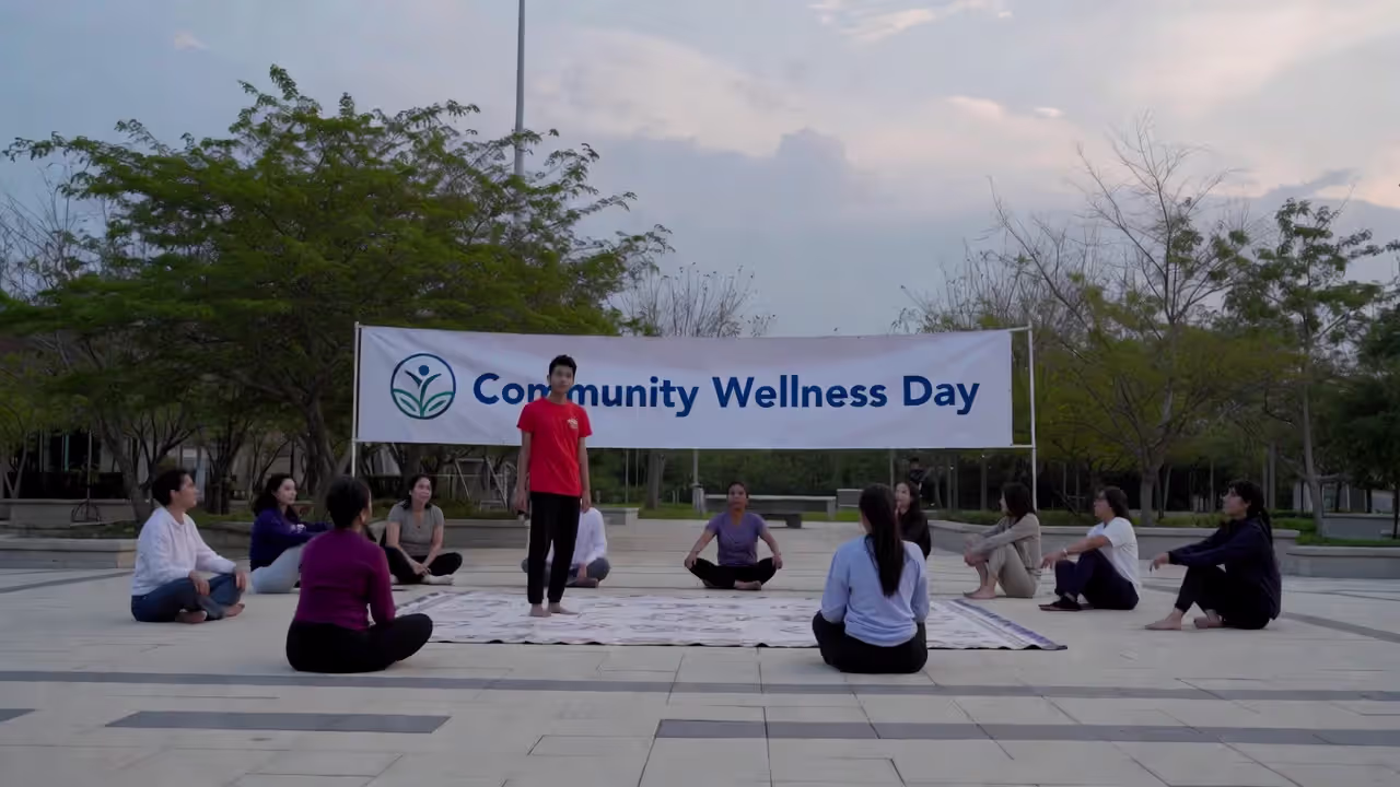 Free yoga workshop at a community wellness event with vendor booths nearby.