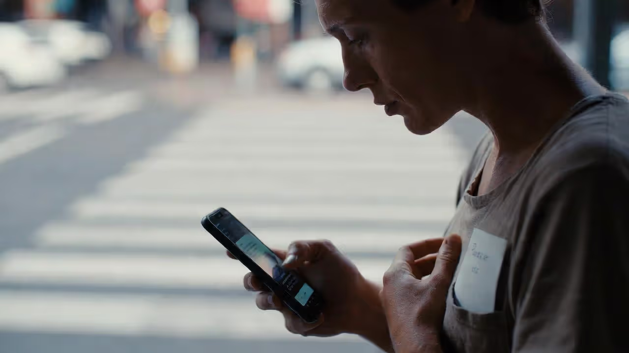 Person practicing mindful breathing before responding to a stressful notification in daily life.