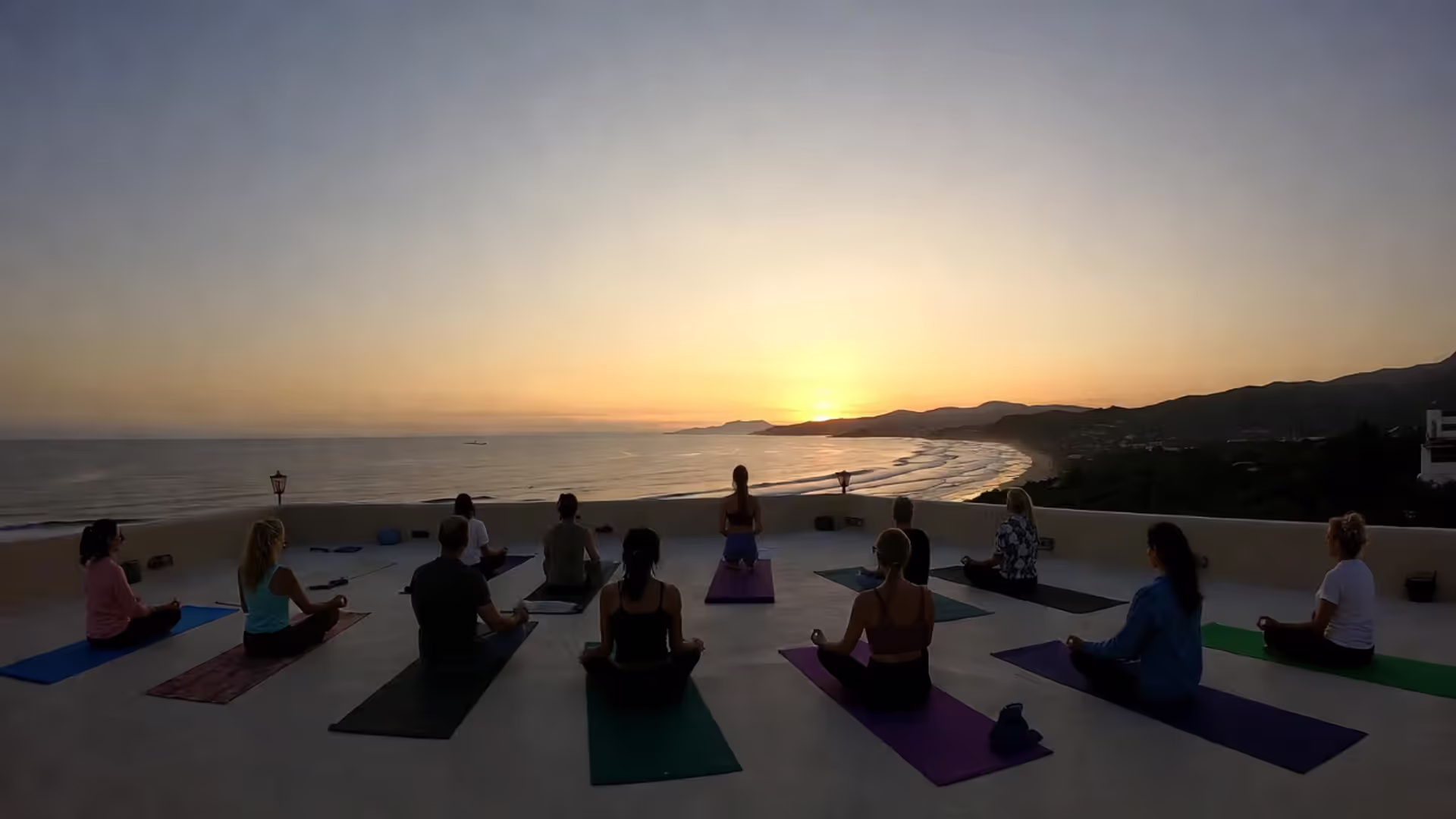 Small-group sunrise yoga and meditation session overlooking the ocean.